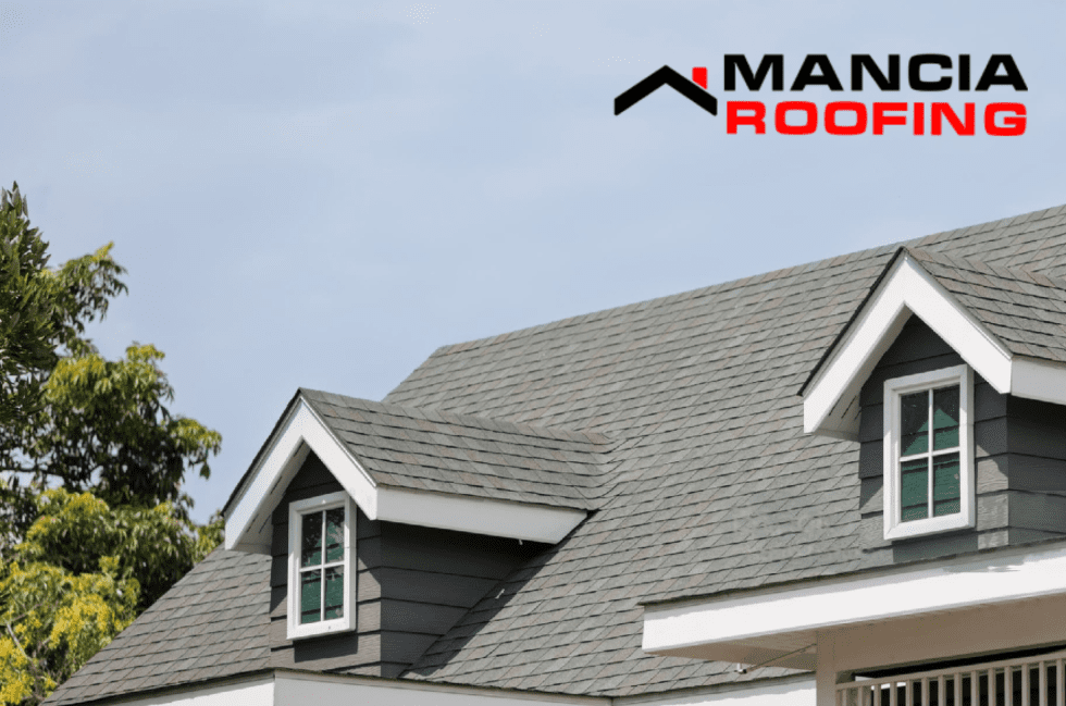House with gray shingles and dormer windows